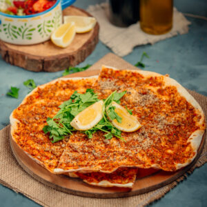 lahmacun with piece of lemon and greens
